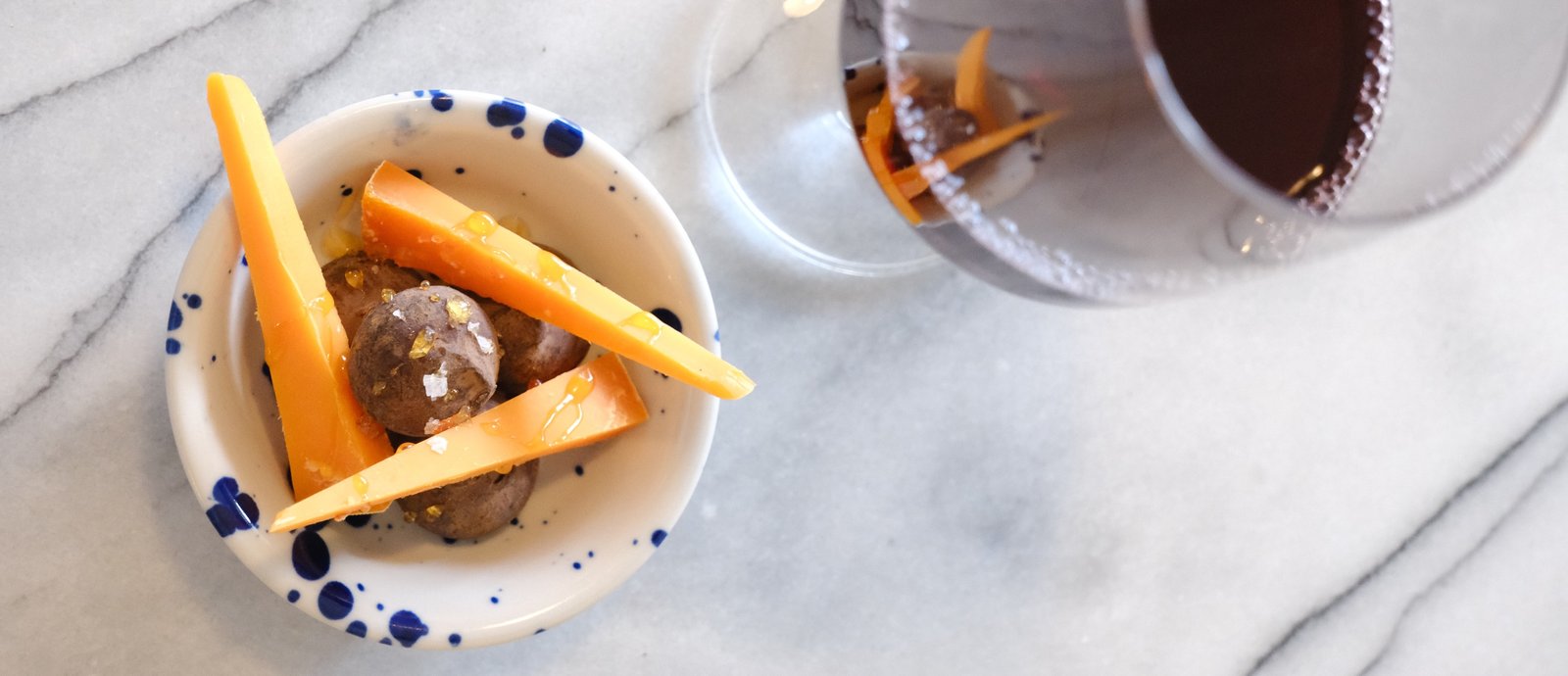 Chocolate truffles and Mimolette with natural wine